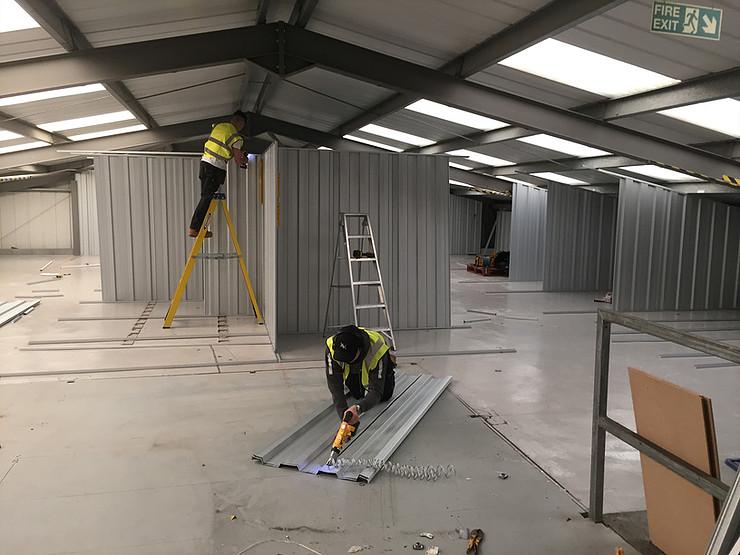 builders working inside storage facility