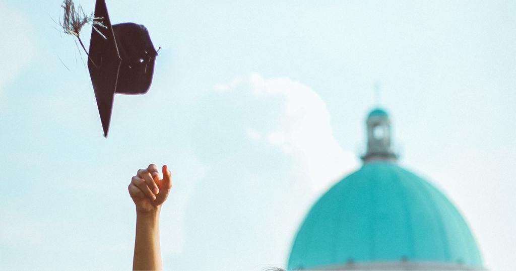 University student throwing hat