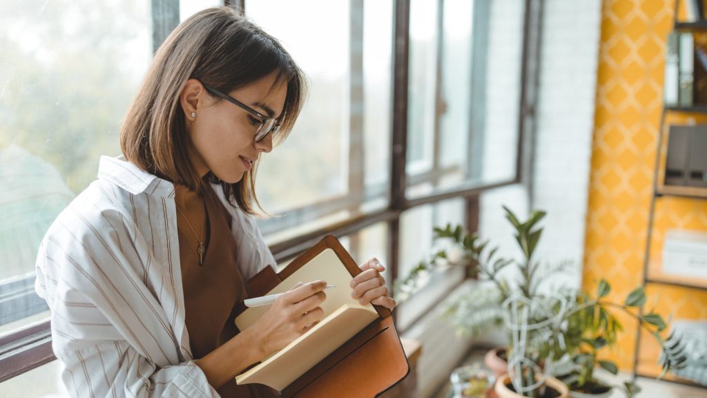 lady writing in book