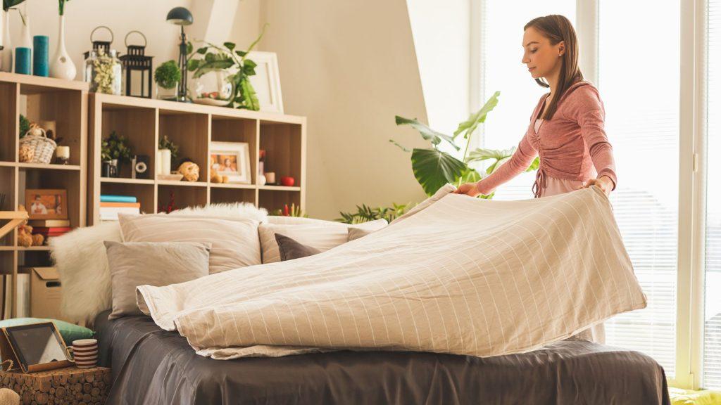 lady making up bed