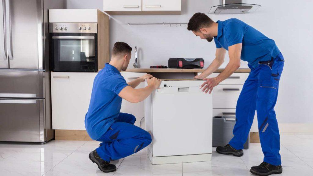 men putting in washing appliance