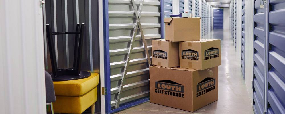 Someone packing their things into a garage full of boxes