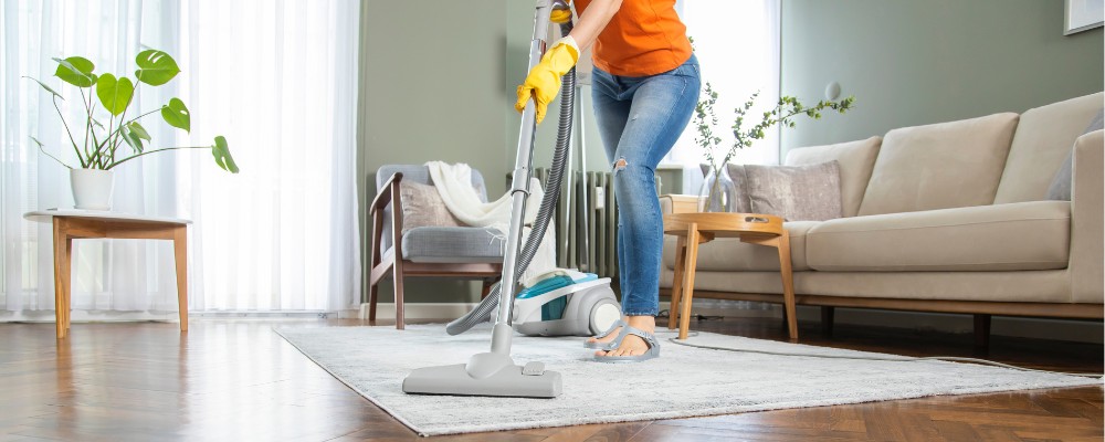 A woman happily cleaning her home