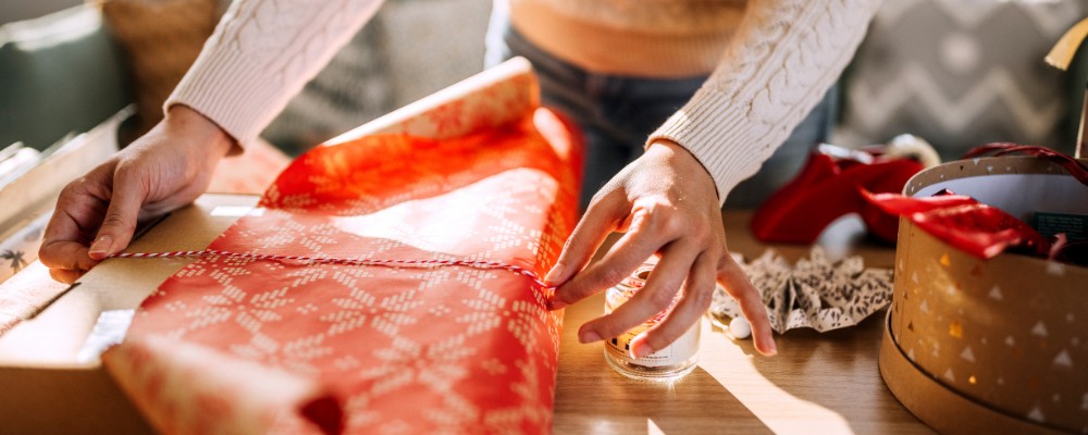 Woman wrapping up a gift