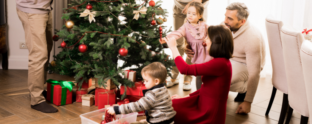 A family standing around their Christmas tree