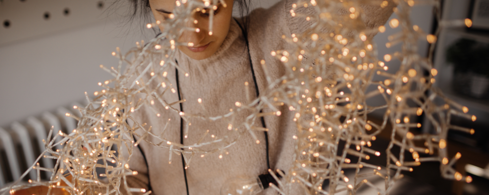 A woman sorting out Christmas lights