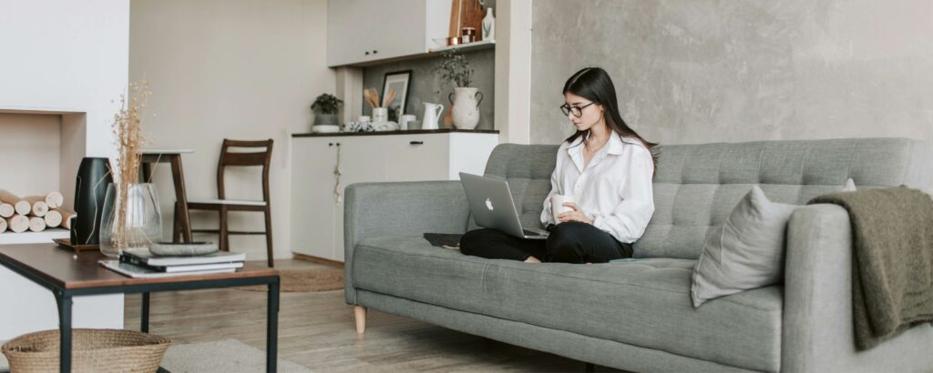 A woman sitting in her small yet spacious apartment