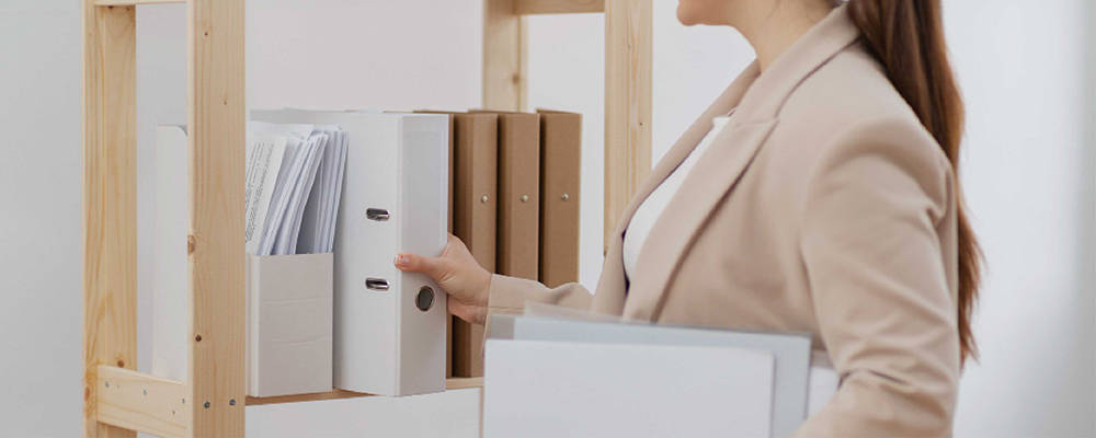 A woman placing files on a rack