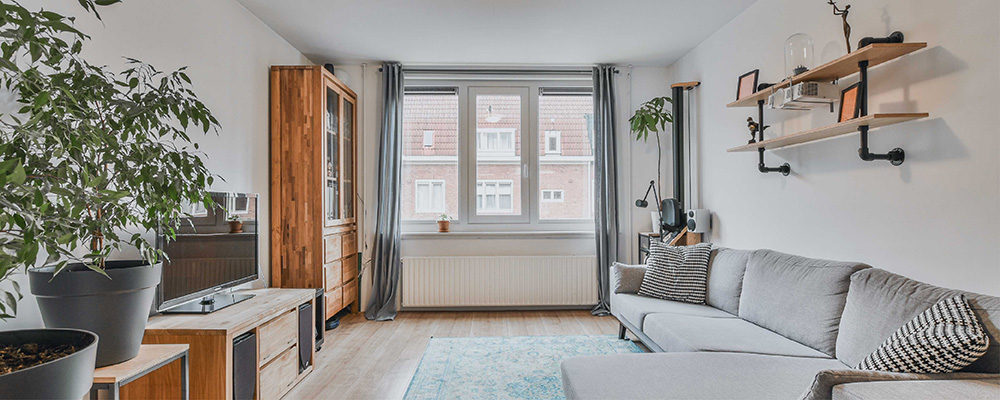 A bright, airy living room with light walls and curtains