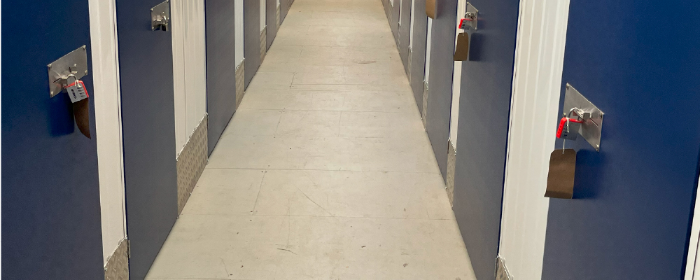 An interior corridor at Louth self storage, featuring padlocked units