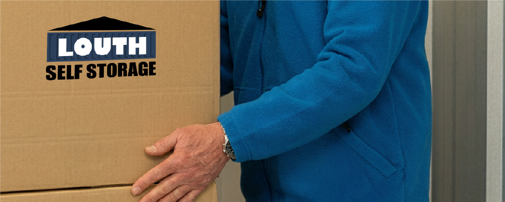 A Louth Self Storage customer packing a box into a unit