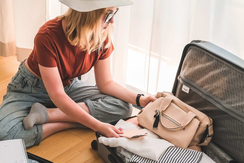 A holiday maker packing her luggage to be placed in short term storage