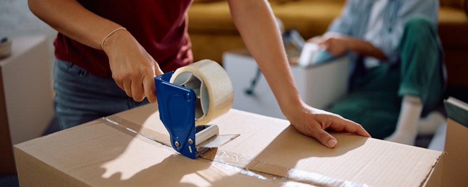 A man taping up a box to be placed in self storage.
