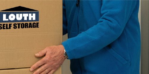 A Louth Self Storage customer packing a box into a unit