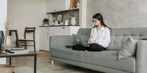 A woman sitting in her small yet spacious apartment