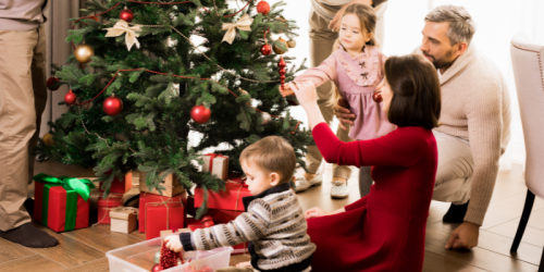 A family standing around their Christmas tree