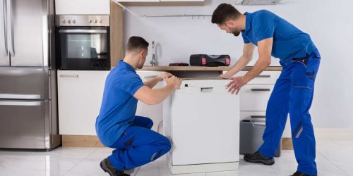 men putting in washing appliance