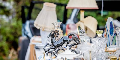 Table at a car boot sale with ornaments and lamps