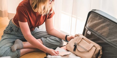 A holiday maker packing her luggage to be placed in short term storage